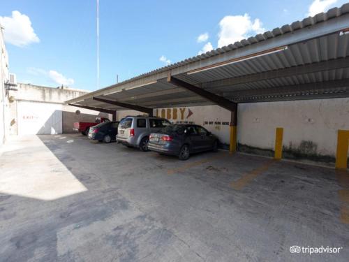 a parking lot with cars parked in a garage at Hotel Doralba Inn in Mérida