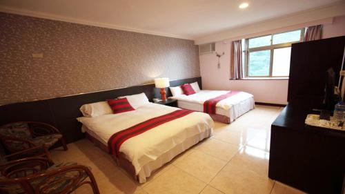 En eller flere senge i et værelse på Liwu Hotel Taroko