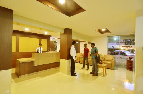 a group of people standing in a waiting room at Hotel A P in Coimbatore