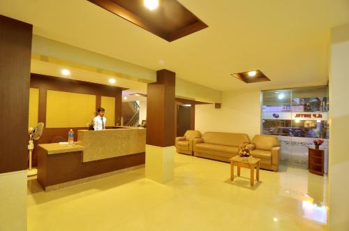 a lobby of a hospital with a person in a waiting room at Hotel A P in Coimbatore