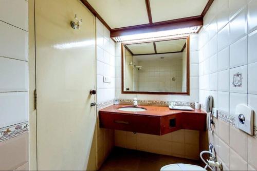 a bathroom with a sink and a mirror at Darling Residency in Vellore