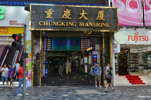 a group of people walking in front of a shopping mall at Unique Hostel in Hong Kong