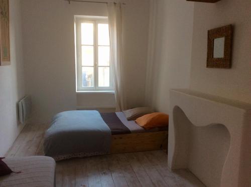 a bedroom with a bed and a window at La planque in Gruissan