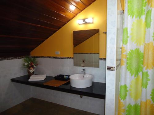 a bathroom with a sink and a mirror at Sea Breeze House, Naiplao Beach in Khanom