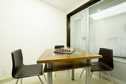 a dining room with a chess board on a table at Pop Inn Mong Kok in Hong Kong