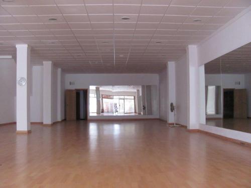 an empty room with a wooden floor and white ceilings at Galaxia Boutique Hotel in Can Picafort