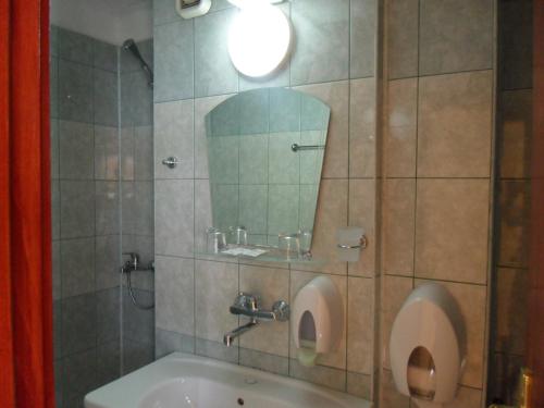 a bathroom with a sink and a mirror at Guest House Hetodon in Sozopol