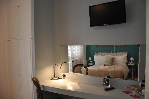 a bedroom with a bed and a desk with a mirror at Sweet Home Parioli in Rome