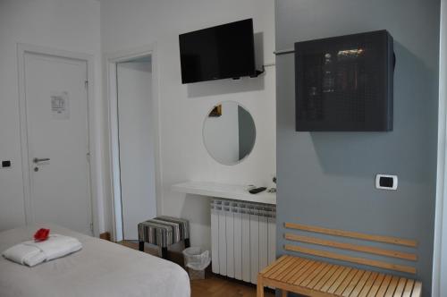 a bedroom with a bed and a tv on the wall at Sweet Home Parioli in Rome
