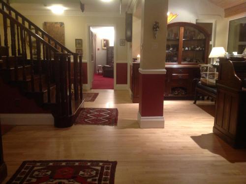 a hallway with a staircase and a living room at Gleann Fia Country House in Killarney