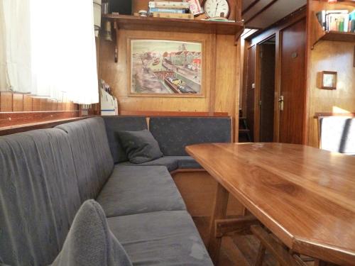a dining room with a couch and a wooden table at MPS Waterland Amsterdam in Amsterdam