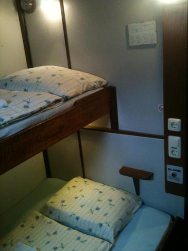 a small room with two bunk beds and a stool at MPS Waterland Amsterdam in Amsterdam