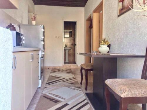 a kitchen with a refrigerator and a table in it at Apartments Zuto in Ulcinj