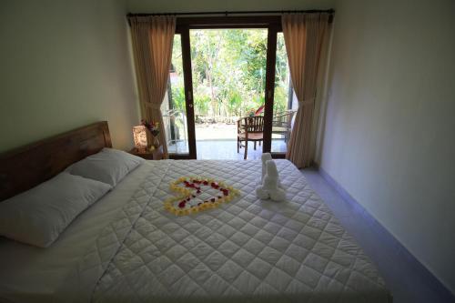 Postel nebo postele na pokoji v ubytování Teba Jati Guest House