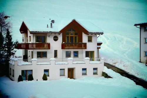 a house with snow on the ground in front of it at Apartment MEZPRA in Samnaun