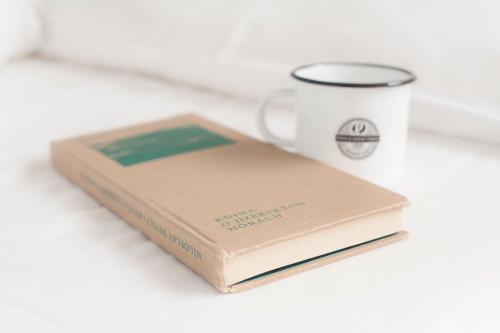 a book sitting next to a coffee mug at Prezidentská in Bedřichov