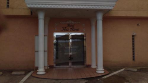 an entrance to a building with columns and a door at Hotel Tea Time (Love Hotel) in Nagasaki