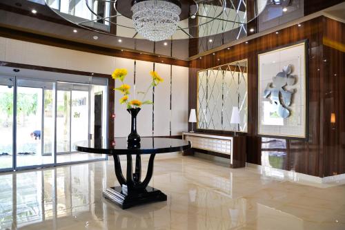 a lobby with a table with flowers on it at Hotel Cartoon Razgrad in Razgrad