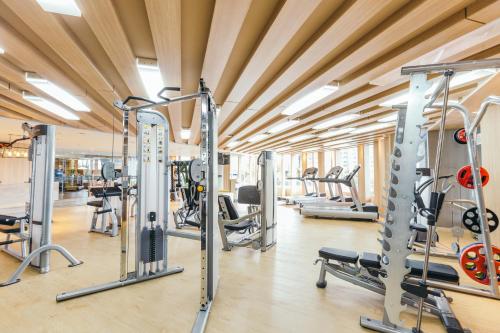 a gym with lots of treadmills and machines at Grand Fortune Hotel Bangkok - SHA Extra Plus in Bangkok