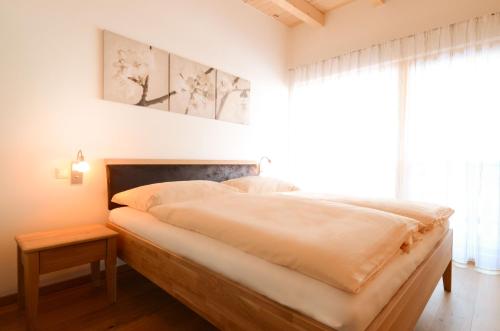 a bedroom with a large bed and a window at Schörghof in Abtenau