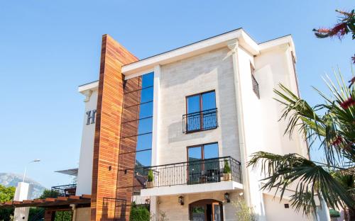 a large white building with a balcony at Hotel Helada in Tivat