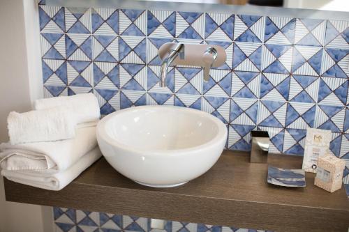 a bathroom with a white bowl sink on a counter at MelRose Relais in Massa Lubrense