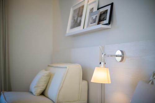 a living room with a chair and a lamp at MelRose Relais in Massa Lubrense