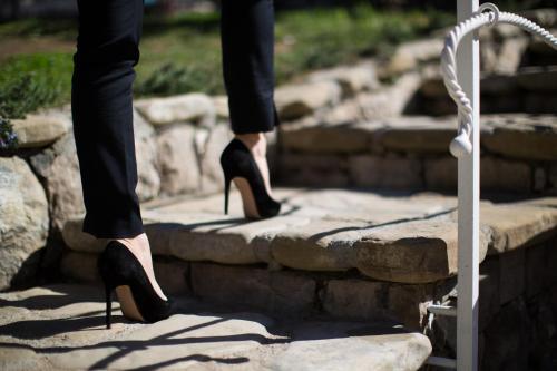 a woman is standing on some steps wearing black heels at MelRose Relais in Massa Lubrense