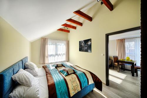 a bedroom with a bed and a large window at Apartamenty Salt Delux in Wieliczka