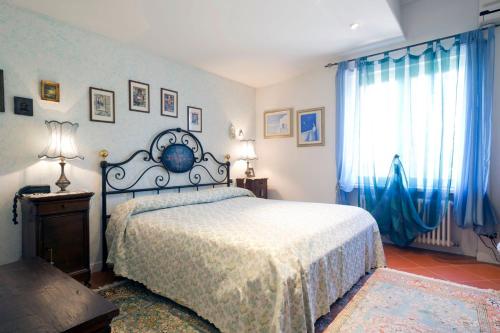 a bedroom with a bed with blue walls and blue curtains at Villa Bellaria B&B in Alseno