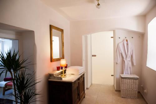 a bathroom with a robe hanging on a door at Gasthof zum Goldenen Anker in Hainburg an der Donau
