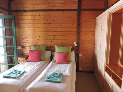 a bedroom with a bed in a wooden wall at Apartamentos Santa Ana - Adults Only in Playa de Santiago