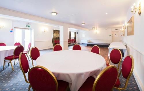 a meeting room with a white table and chairs at The Riverside Hotel in Monmouth