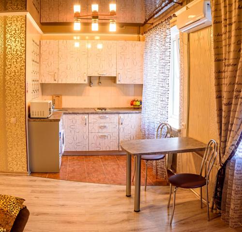 a kitchen with a table and a refrigerator at John Hovard High Level VIP 2019 in Kherson