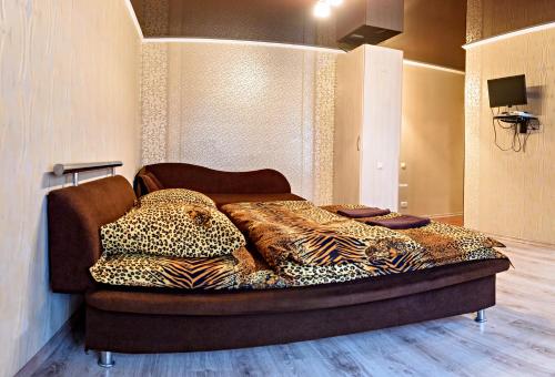 a bedroom with a bed with leopard pillows on it at John Hovard High Level VIP 2019 in Kherson