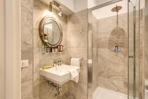 a bathroom with a sink and a shower at Charme Spagna Boutique Hotel in Rome