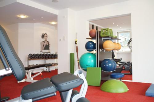 a gym with a treadmill and exercise equipment at Hotel Franks in Oberstdorf
