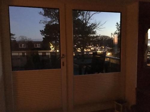 an open door with a view of a balcony at Seaside-Strandhotel in Timmendorfer Strand