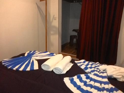 a bed with blue and white towels on it at Maafushi View in Maafushi