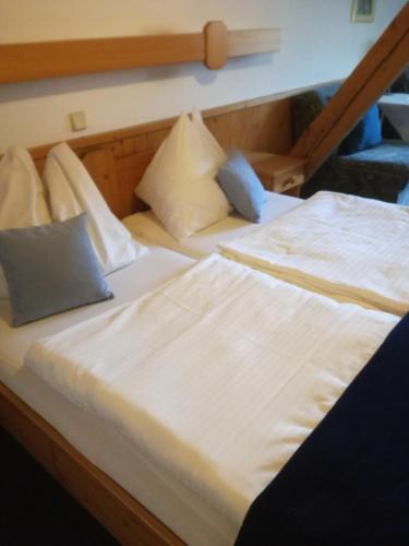 two beds sitting next to each other in a room at Gasthof Platzschmied in Guttaring