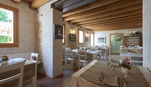 Giavera del MontelloにあるAgriturismo la paternaのテーブルと椅子が備わるレストラン