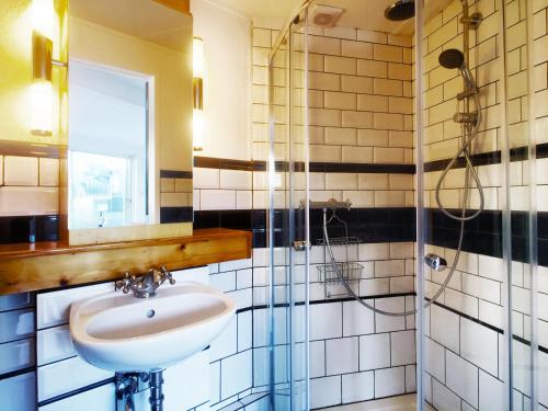 a bathroom with a sink and a shower at Houseboat Concordia B&B in Amsterdam