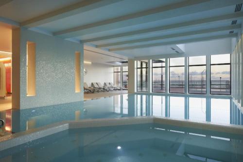 a swimming pool with a view of a building at Real Marina Hotel & Spa in Olhão