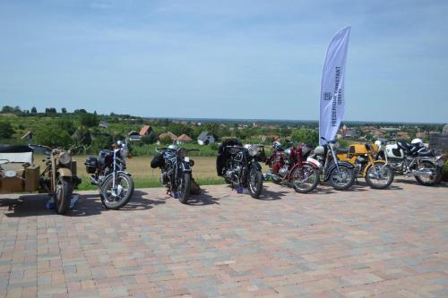 a group of motorcycles parked in a parking lot at St Peter Vini in Svätý Peter