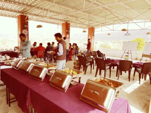 a group of people standing around a table with food at Ranthambhore Tiger Valley in Sawāi Mādhopur