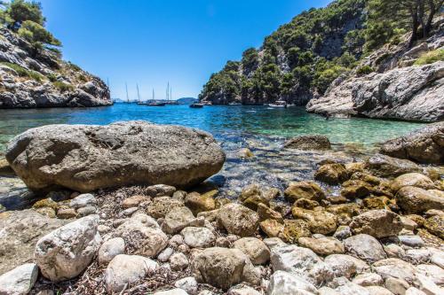 a group of rocks on the shore of a river at Duplex La Nau By homevillas360 in Port de Pollensa