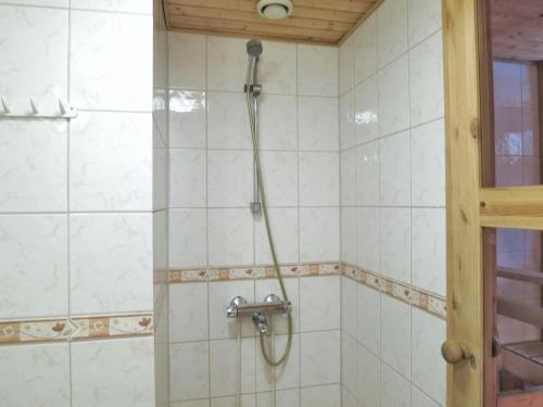 een douche met een slang in een betegelde badkamer bij Seilorin Lomakylä in Luvia