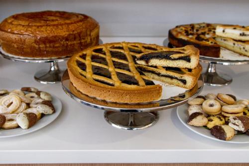 a table with different types of cakes and other desserts at Hotel Gravina San Pietro in Rome