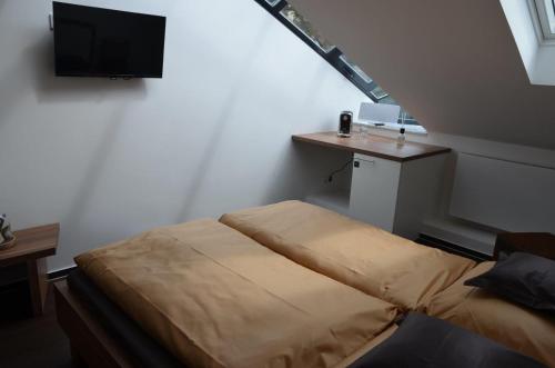 a bedroom with a bed and a tv on the wall at Seaside-Townhouse in Timmendorfer Strand