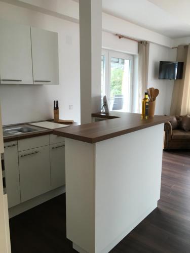 a kitchen with white cabinets and a counter top at Seaside-Townhouse in Timmendorfer Strand